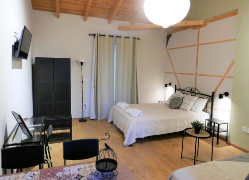 a bedroom with a bed and a television in it at Fox Tale Guest House in Fternón