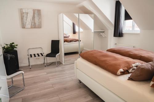 a bedroom with two beds and a mirror at Ferienwohnung Leonie nahe Detmold Zentrum in Detmold