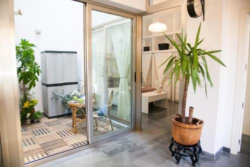 a room with a sliding glass door with a potted plant at BEAUTIFUL&SILENT APARTMENT. PARKING FREE in Seville