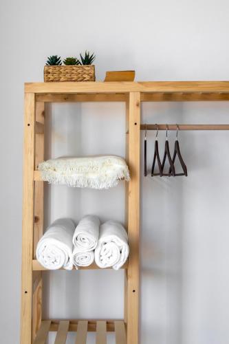 a wooden towel rack with towels on a shelf at Born in Blue in Kaş