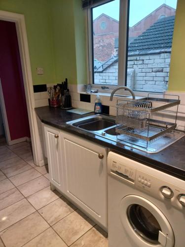 a kitchen with a sink and a washing machine at Ripon Street Lincoln in Lincoln