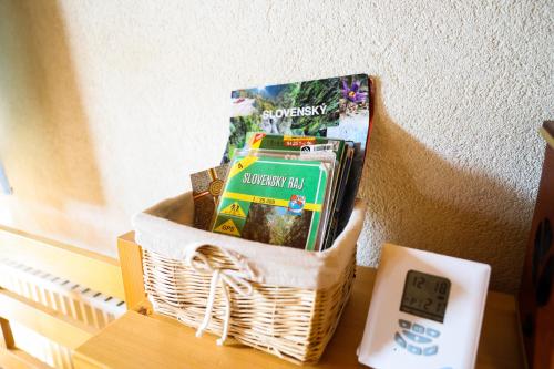 a basket of groceries on a table next to an alarm clock at Chata u Gregora v Slovenskom raji in Smižany