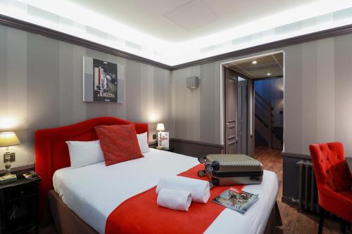 a hotel room with a bed with a red blanket at Alexandra in Lyon