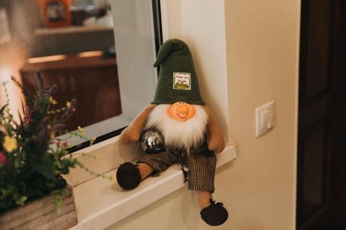 a stuffed animal is sitting on a window sill at Guest House Lorem in Daugavpils