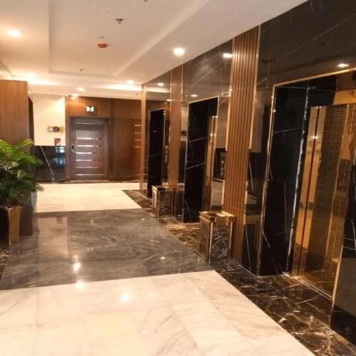 a lobby with black marble floors and a door at شقق ارين المطار in Jeddah