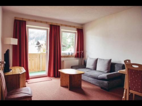 a living room with a couch and a table at Landhaus Cornelia in Berwang