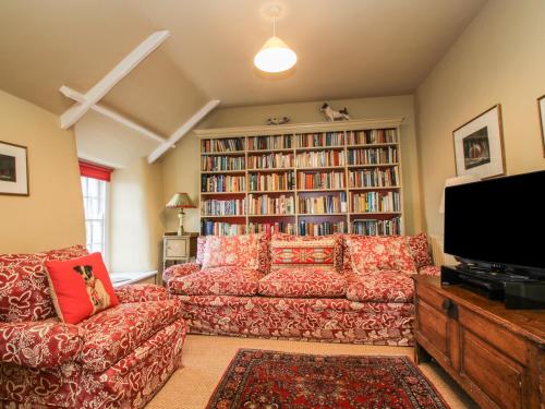 a living room with a couch and a tv at Mount View in Penzance