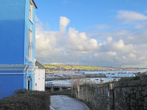 a blue building with a view of a harbor at Mount View in Penzance