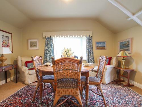 a dining room with a wooden table and chairs at Mount View in Penzance