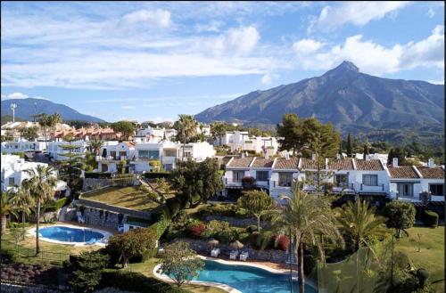 a view of a resort with a mountain in the background at Las Pergolas in Marbella