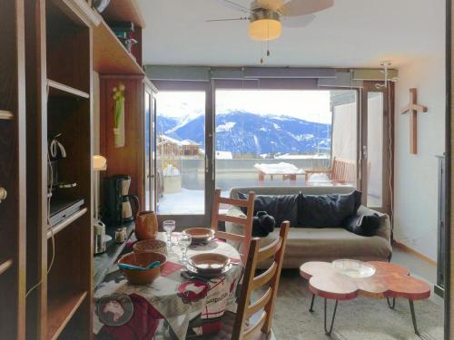 a living room with a table and a couch at Studio Jeanne D'Arc Apt- E-36 by Interhome in Crans-Montana