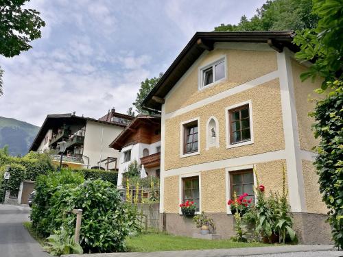a yellow house with flowers on the side of it at Chalet Dr-Steiner by Interhome in Zell am See