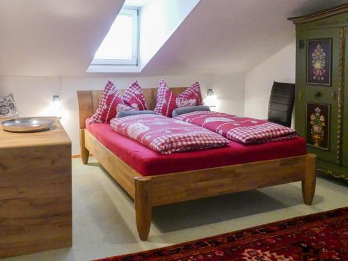 a bed with pillows on it in a room at Chalet Dr-Steiner by Interhome in Zell am See