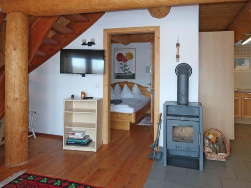 a living room with a stove and a bedroom at Holiday Home Nikola by Interhome in Flachau