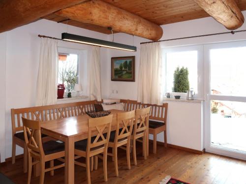 a dining room with a wooden table and chairs at Holiday Home Nikola by Interhome in Flachau