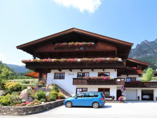 a blue car parked in front of a building at Apartment Theresia - APH310 by Interhome in Alpbach