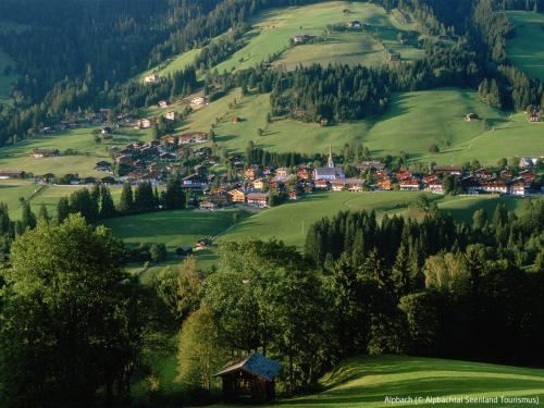 a small village on a green hill with trees at Apartment Theresia by Interhome in Alpbach