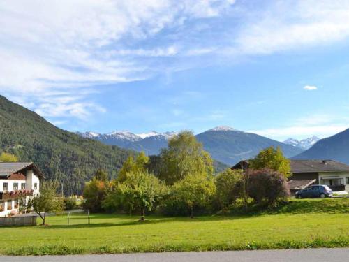 a view of a yard with mountains in the background at Apartment Edith - IST100 by Interhome in Imst