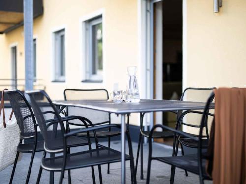 a table with chairs and wine glasses on it at Apartment Edith-1 by Interhome in Imst