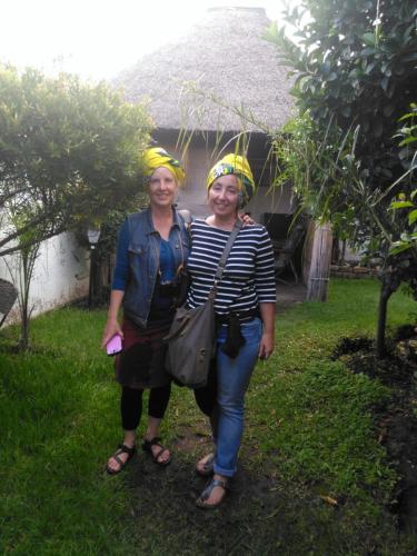 two women standing next to each other in the rain at Authentic Bicycle Tours and Backpackers in Soweto
