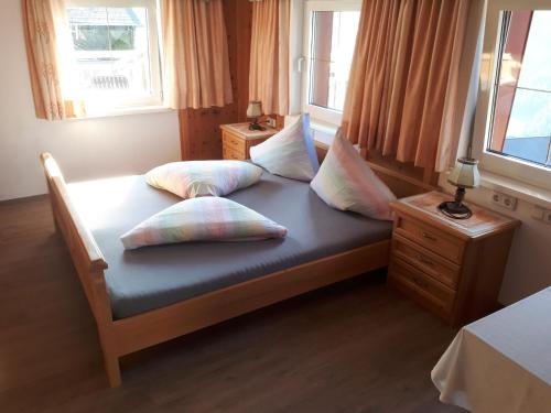a bed in a room with two pillows on it at Apartment Selina by Interhome in Kappl