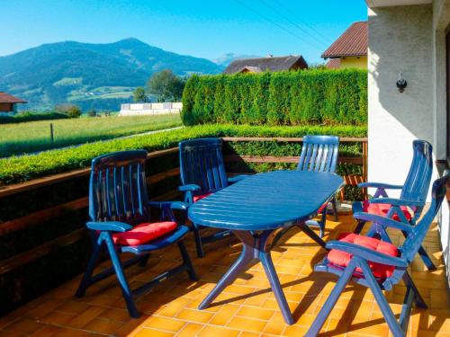 a blue table and four chairs on a patio at Holiday Home Katharina - GBM220 by Interhome in Gröbming