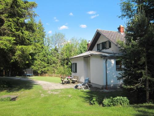 a white house with a patio and a picnic table at Holiday Home Landhaus Grüne Oase - OBL120 by Interhome in Sankt Martin am Grimming