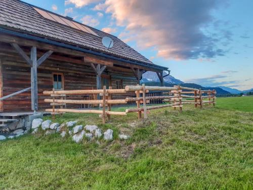 a wooden barn with a fence in front of it at Chalet Steiners Blockhütte by Interhome in Stein an der Enns