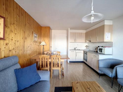 a kitchen and living room with a table and chairs at Apartment Bellevue L by Interhome in Veysonnaz