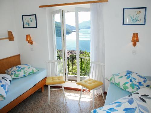 a bedroom with a bed and a window with a view at Holiday Home Christa by Interhome in Bissone