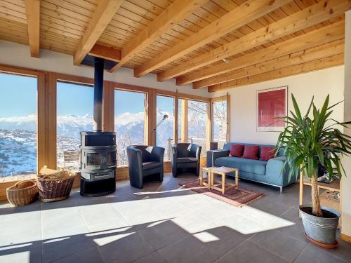 a living room with a couch and a stove at Chalet au Bisse by Interhome in Veysonnaz