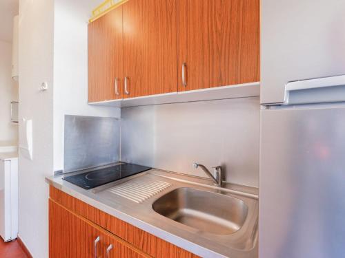 a kitchen with a sink and a refrigerator at Apartment Mare Nostrum by Interhome in Cap d'Agde