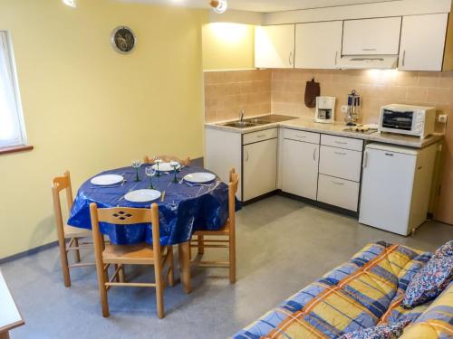 una cucina e un tavolo con una tovaglia blu di Apartment Résidence jaune et rose-2 by Interhome a Marckolsheim