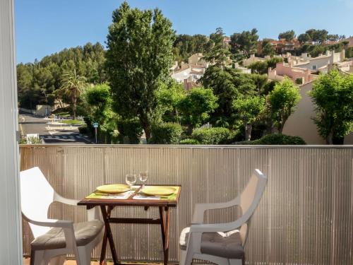 a table and chairs on a balcony with a view at Apartment Les Aigues Marines-36 by Interhome in La Madrague