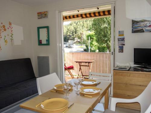 a living room with a table and a couch at Apartment Les Aigues Marines-36 by Interhome in La Madrague