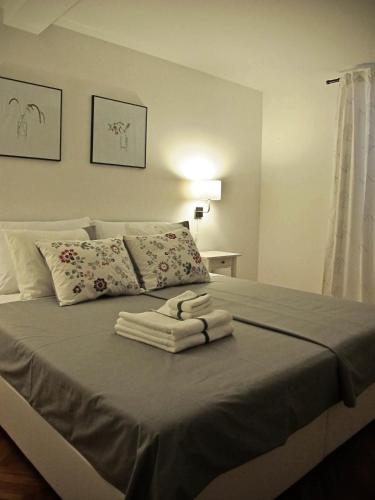 a bedroom with a bed with towels on it at Fiorino Rooms Korčula in Korčula