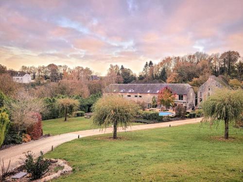 a house in a field with trees and a road at Au bout de mes rêves in Walcourt