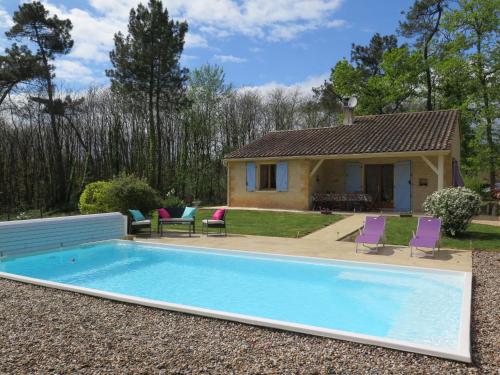 a swimming pool in front of a house at Holiday Home Au Cayroux by Interhome in Blanquefort-sur-Briolance