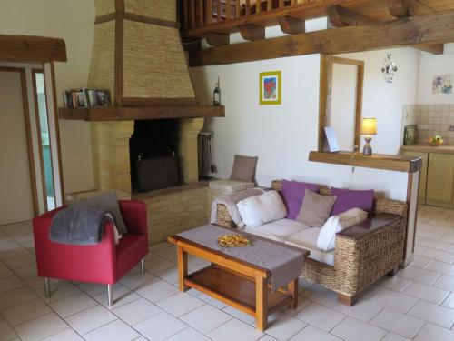 a living room with a couch and a table at Holiday Home Au Cayroux by Interhome in Blanquefort-sur-Briolance