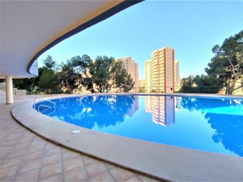 a swimming pool with a view of a city at Apartment Coblanca XVI by Interhome in Cala de Finestrat