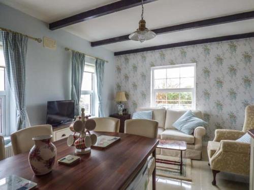 a living room with a couch and a table at No 1 Apt, Brandy Harbour Cottage in Kilcolgan