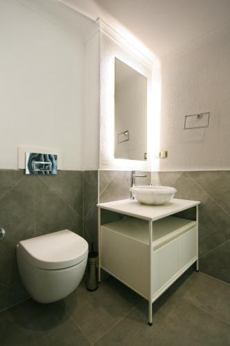 a bathroom with a white toilet and a sink at Arnna Hotel in Kas