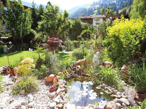 a garden with a pond in the middle of a yard at Apartment Hundsbichler-2 by Interhome in Hippach