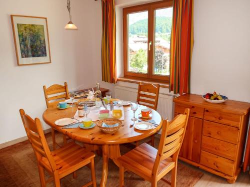 a dining room with a wooden table and chairs at Apartment Hanneshof-2 in Aurach bei Kitzbuhel
