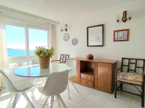 a dining room with a table and chairs and a window at Apartment Turia Playa by Interhome in Benidorm