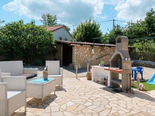 a patio with a pizza oven in a yard at Apartment Vesna - MLK155 by Interhome in Dobrinj