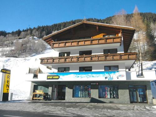 a building on the side of a snow covered mountain at Apartment Erika by Interhome in Kappl