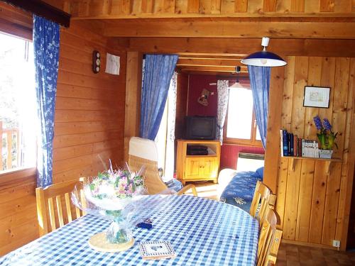 a dining room with a table with a blue table cloth at Chalet Gerbepal by Interhome in Gerbépal