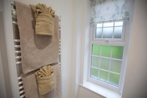 a room with a window and towels on the wall at Waterfall Cottage in Launceston