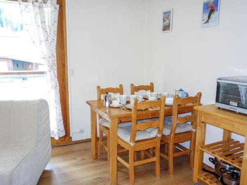 a dining room with a table and chairs and a tv at Studio L'Enclave I et J-28 by Interhome in Les Contamines-Montjoie